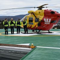 Westpac Rescue helicopter crew disembarked and walking inside to inspect the helipad foyer. From left to right, Garry White (Ambulance Tasmania), Peter McKenzie (Rotorlift Pilot), Dave Davies (Rotorlift Co-Pilot) and Rod Stacey (Tasmania Police)
